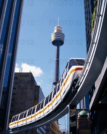 AUSTRALIA , New South Wales , Sydney, Mono rail train between skyscrapers with Sydney Tower behind.