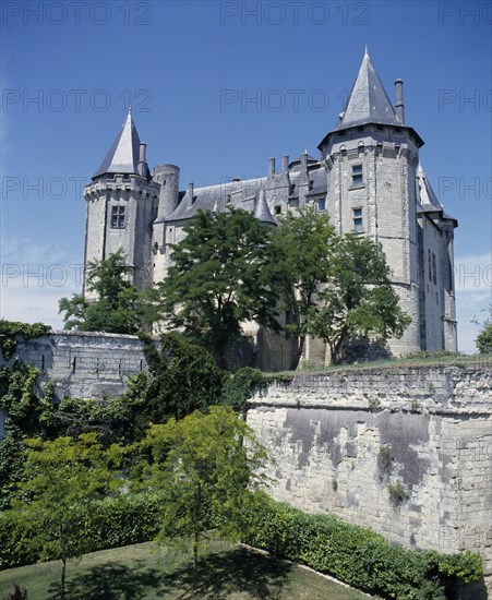 FRANCE, Loire Valley, Saumur Chateau, Looking over the garden with high walls up to the chateau with turrets.
