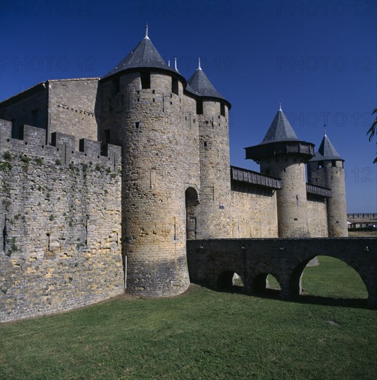 FRANCE, Languedoc Roussillon  Aude, Carcassonne , Fortified old town walls Chateau Comtal General view including bridge across dry moat