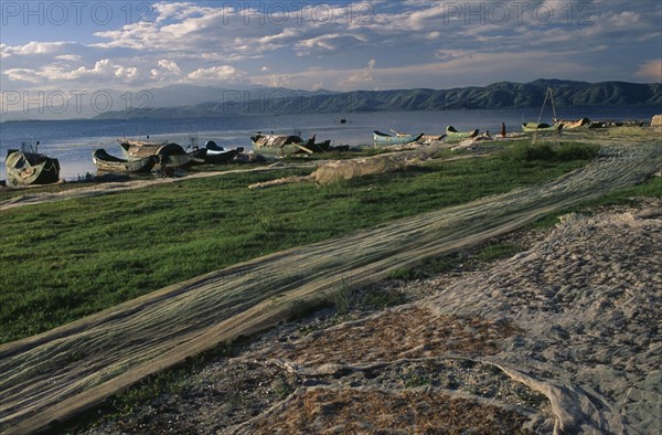 CHINA, Yunnan, Dali , Drying nets and fishing boats beside Er Hai Lake.