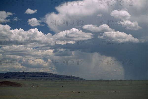 MONGOLIA, Madalgov , Two gers or yurts in departing storm rain falling