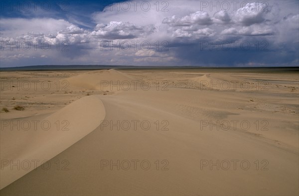 MONGOLIA, South Gobi , Vast expanse of desert sand dunes and cloudscape.