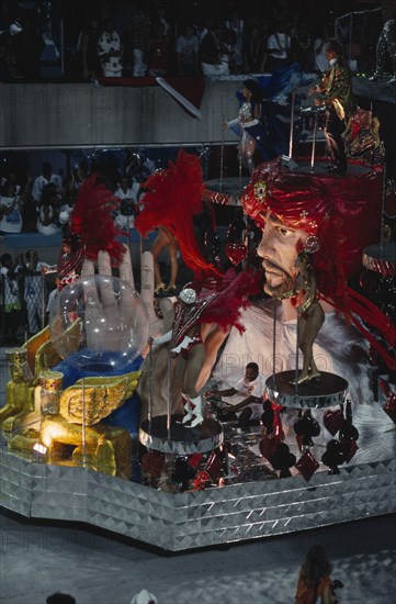 BRAZIL, Rio de Janeiro, Carnival float with large model of a fortune teller and crystal ball surrounded by carnival dancers