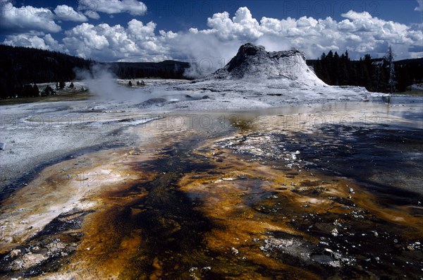USA, Wyoming, Yellowstone National Park, Hot springs with ashen pool of acid dissolved mud and clay in the foreground