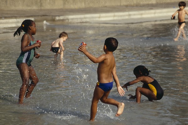 ENGLAND, London, Kids playing Clapham paddling pool.