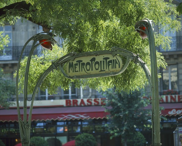 FRANCE, Ile de France, Paris, Art Nouveau `Metropolitain' sign in green wrought iron under tree branches