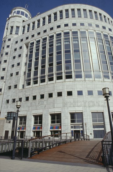 ENGLAND, London, Round sided office block with shops on the ground floor near Canary Wharf