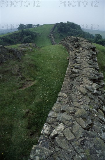 ENGLAND, Northumbria, Hadrians Wall, Stretch of the wall between Greenhead and Vindolanda dissapearing over the hills