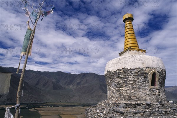 CHINA, Tibet, Yambu Lhakang Monastery, Chorten and prayer flags.