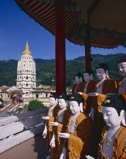 MALAYSIA, Penang, Kek Lok Si Temple, "Ban Po, the Pagoda of a Thousand Buddhas.  Seven tier pagoda with double row of standing buddha figures under canopy in the foreground. "