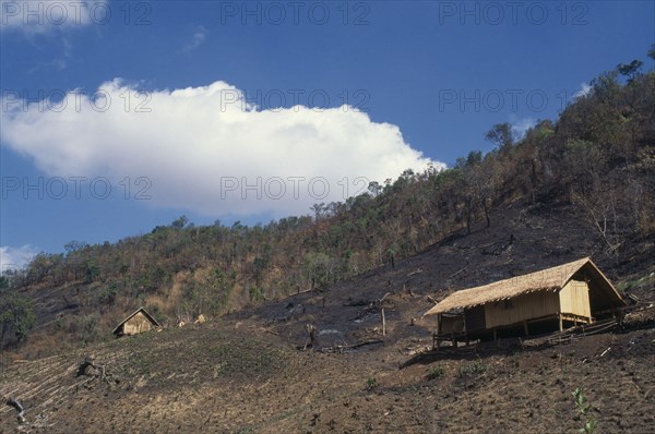 Myanmar, Farming, Slash and burn country with small wooden huts in cleared forest area