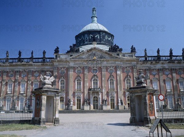 GERMANY, Potsdam, Sanssouci, The New Palace facade and dome seen through the entrance gates