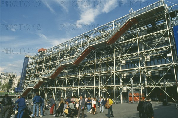 FRANCE, Ile de France, Paris, Beaubourg. Exterior view of the Pompidou Centre facade with gathered crowds in the foreground