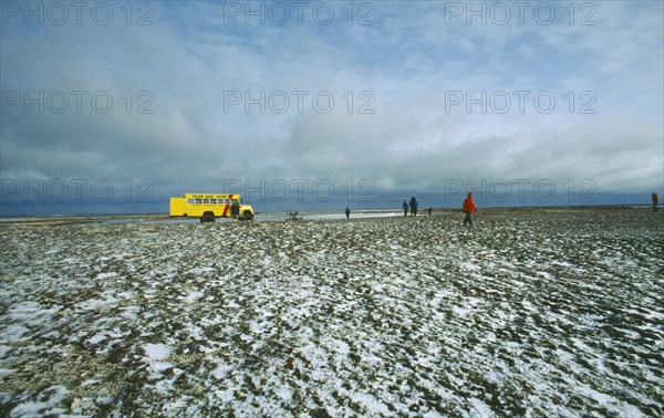 CANADA, Manitoba, Near Churchill, Tundra bus tourists walking in Polar Bear country