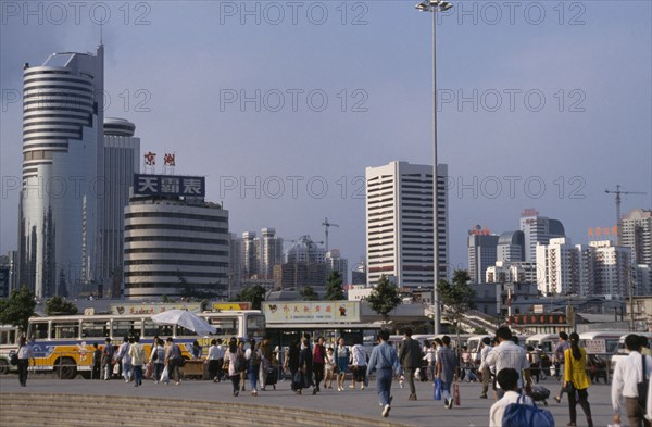 CHINA, Guangdong, Shenzhen, "Special Economic Zone, city buildings, buses and crowds of pedestrians."