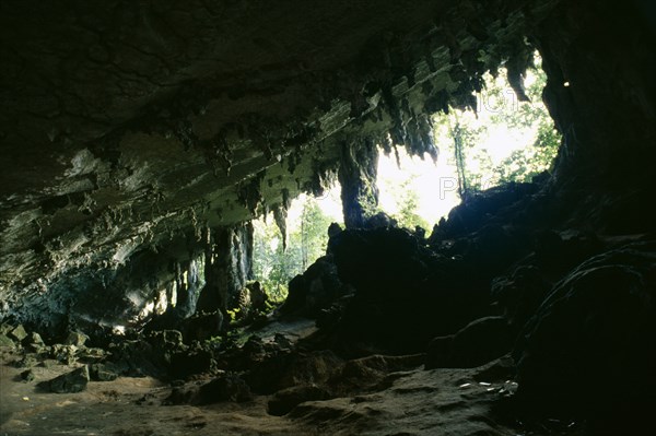 MALAYSIA, Sarawak, Niah Caves, View from rocky interior with hanging stalactites looking toward opening