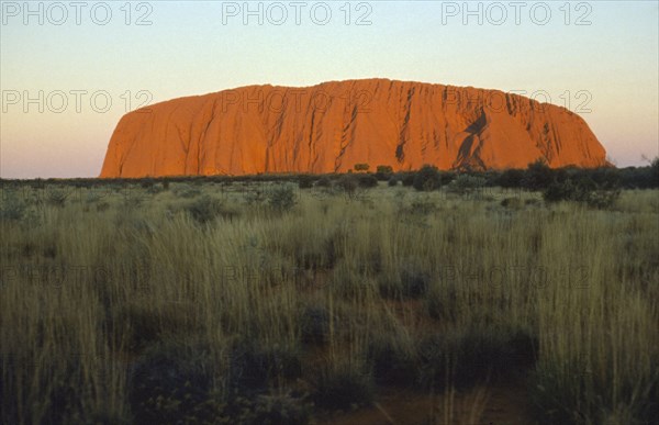 AUSTRALIA, Northern Territory, Uluru, Ayers Rock at sunset.