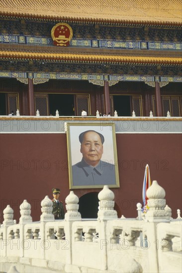 CHINA, Hebei, Beijing , Policeman standing under a picture of Chairman Mao