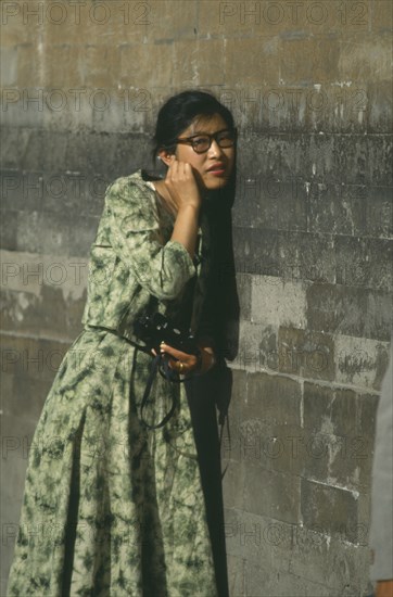 CHINA, Hebei, Beijing, Temple of Heaven.Woman standing next to wall