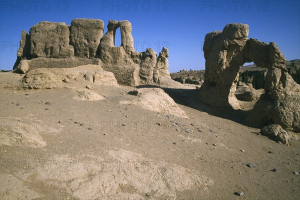 CHINA, Xinjiang, Jiaohe ruins, View of ruined buildings in rocky arid landscape