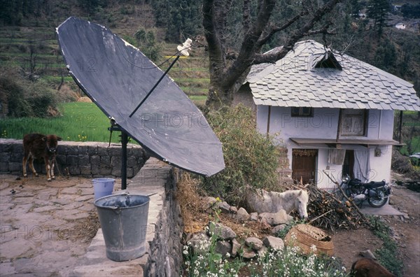 INDIA, Dharamsala , Comunications, Satelite Dish in a bucket on the wall of  a remote country home.