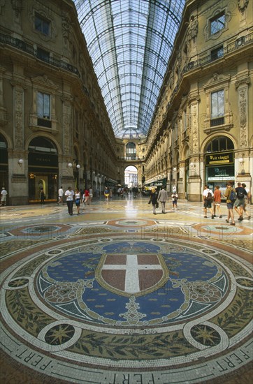 ITALY, Lombardy , Milan, Galleria Vittorio Emanuele II shopping arcade interior with arched glass roof and mosaic floor lined with designer shops.