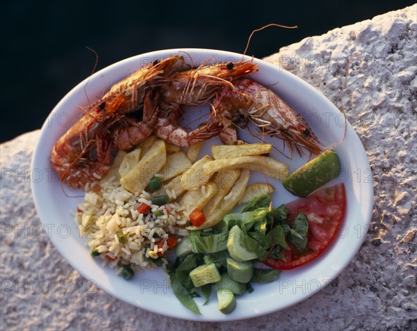 FOOD, Seafood, "Plate of shrimps with rice, chips and salad Greek tourist meal"