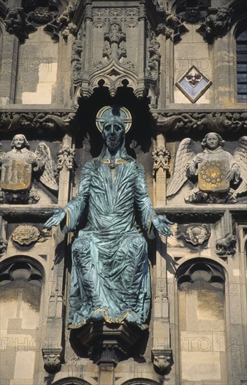 ENGLAND, Kent, Canterbury Cathedral, Green statue of Christ mounted on the ornate stone facade