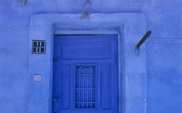 EGYPT, Eastern Desert, Hurghada, Detail of blue painted house and entrance with a starfish above a doorway in this Red Sea coastal town