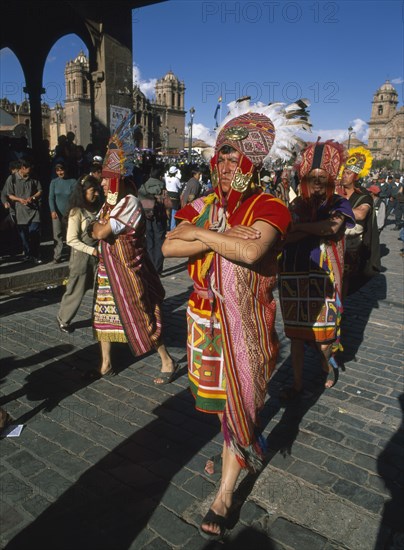 PERU, Cusco Department, Cusco, Street parade of men in traditional costume and head dress at Inti Raymi.