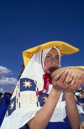 PERU, Cusco Department, Cusco, Young woman in traditional costume at Inti Raymi.