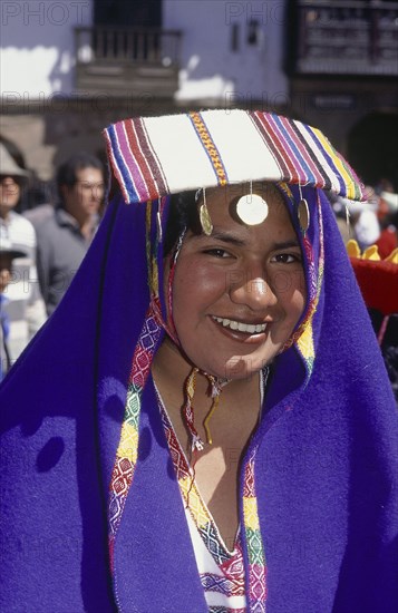 PERU, Cusco Department, Cusco, Young woman in traditional costume at Inti Raymi.  Head and shoulders shot.