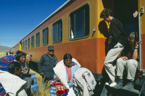 PERU, Puno Department, "Train stopped at the altiplano on the highest pass on the line between Puno to Cusco, passengers disembarking.  "