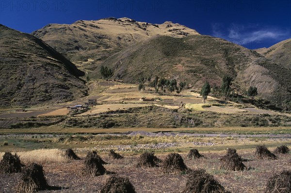 PERU, Puno Administrative Department, La Raya, "View from the train on the altiplano at La Raya.  Agricultural land in the foreground, mountains beyond.  "