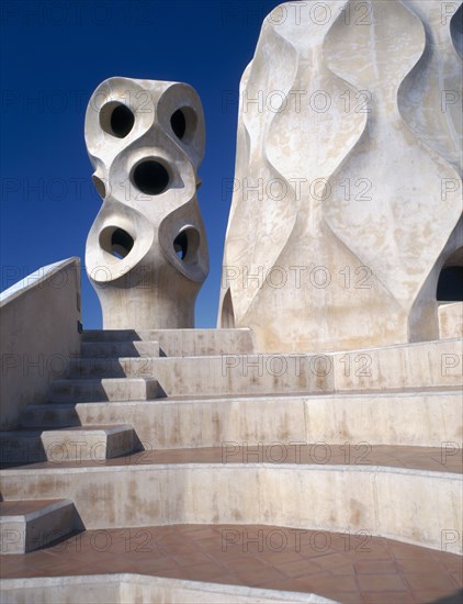 SPAIN, Catalonia, Barcelona, "La Pedrera.  Gaudi architecture, carved chimney pots and curved steps on the rooftop."