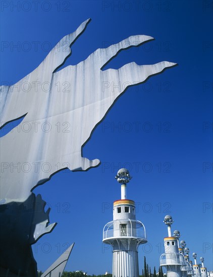 SPAIN, Catalonia, Barcelona, "Parc Espanya Industrial.  Abstract sculpture in foreground, line of towers with balconies encircling them. "