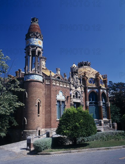 SPAIN, Catalonia, Barcelona, "Hospital de Sant Pau designed by Domenech I Montaner.  Ornate facade with arched windows, domed roof and turret.   "