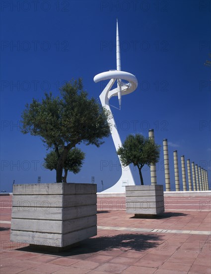 SPAIN, Catalonia, Barcelona, "Olympic stadium.  The Torre Calatrava, trees planted in stone tubs on a paved area in the foreground.    "