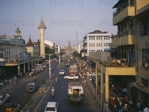 MYANMAR, Yangon, "View over busy pavements, city architecture and wide, central road. "