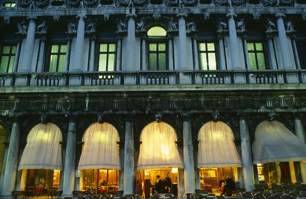 ITALY, Veneto, Venice, "Piazetta San Marco.  Café at night, detail of facade showing balcony, windows and lighted interior."