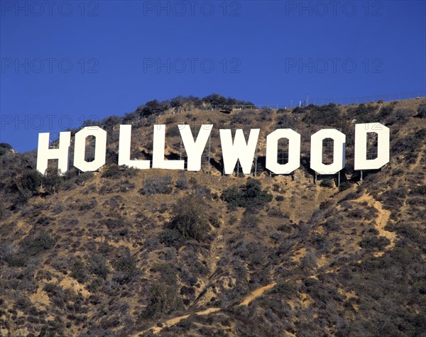 USA, California, Los Angeles, The Hollywood Sign on hillside with blue sky behind