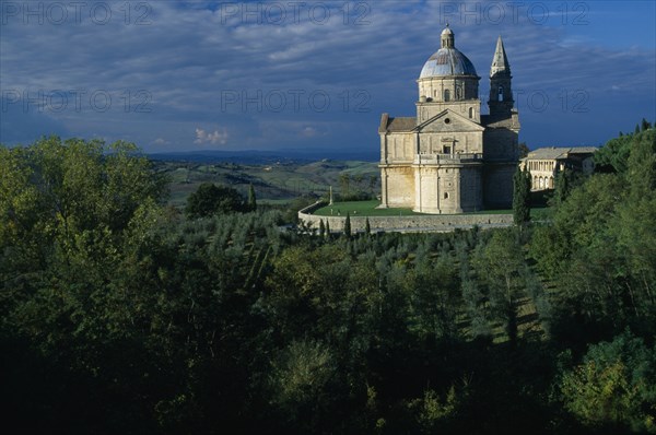 ITALY, Tuscany, Montepulciano, "Tempio di San Biagio, High Renaissance church with domed roof surrounded by trees."