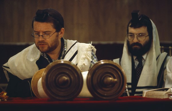 SOCIETY, Religion, Judaism, Two Rabbis saying Mincka prayers in front of Torah scrolls inside Catford Synagogue