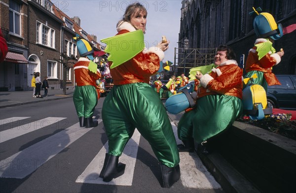 BELGIUM, Brabant, Brussels, "Woluwe St. Lambert, Spring Festival.  Group of people in green and orange Mardi Gras costumes."