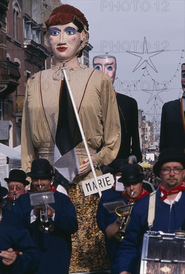 BELGIUM, Brabant, Brussels, "Woluwe St. Lambert, Spring Festival.  Parading bandsmen with giant figures in costume behind them."