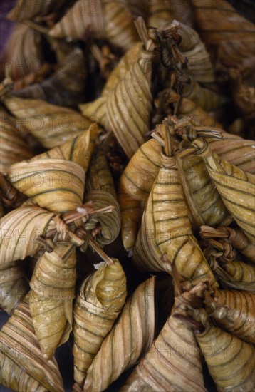 MALAYSIA, Kedah, Langkawi, Pulut a coconut rice dish wrapped in banana leaves on a stall at the Night Market in Cenang