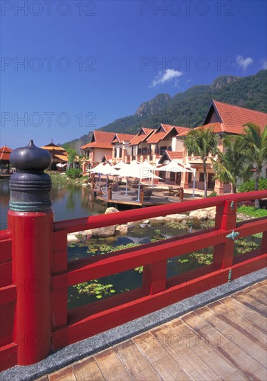 MALAYSIA, Kedah, Langkawi, Oriental Village shopping complex at Burau Bay set around an artificial lake with Gunung Mat Cincang behind