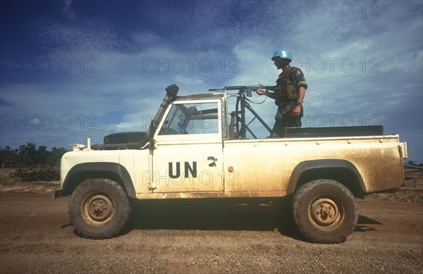CAMBODIA, Thmar Pouk, Dutch made UN jeep with a soldier standing behind a mounted rifle in the back.