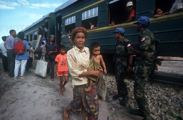 CAMBODIA, Phnom Pehn, Second UN HCR train repatriating people from Khmer Rouge sites.  Woman holding a child in the foreground.