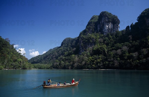 MALAYSIA, Kedah, Langkawi, Pulau Dayang Bunting island with hunters arriving in a traditional long boat